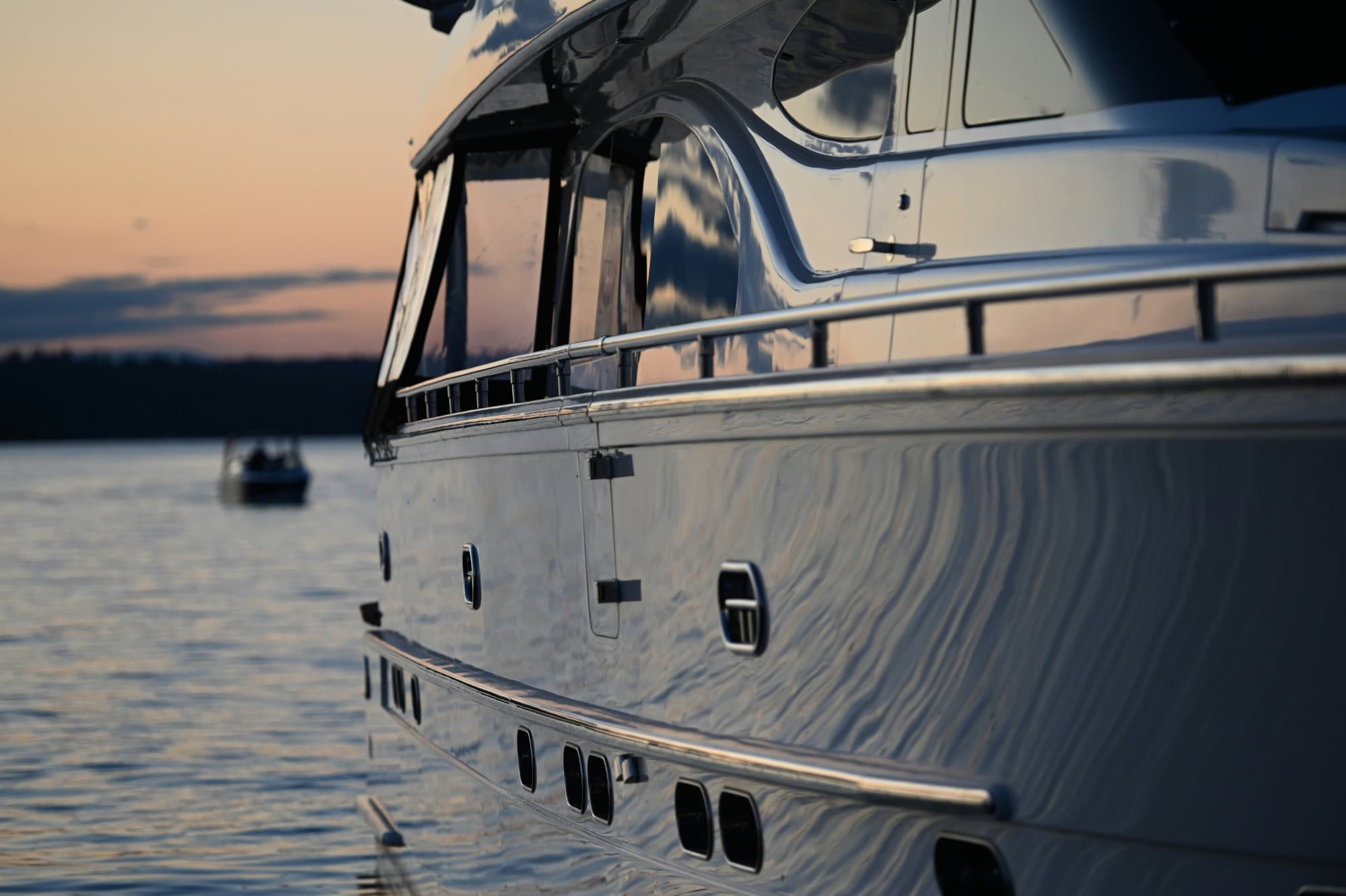 Polished boat hull and cabin at sunset on the water