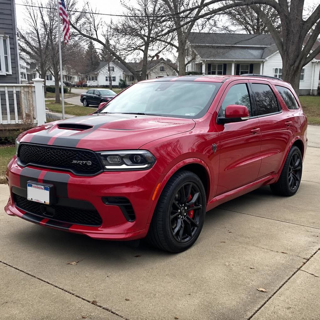 A red Dodge Durango in a residential driveway.